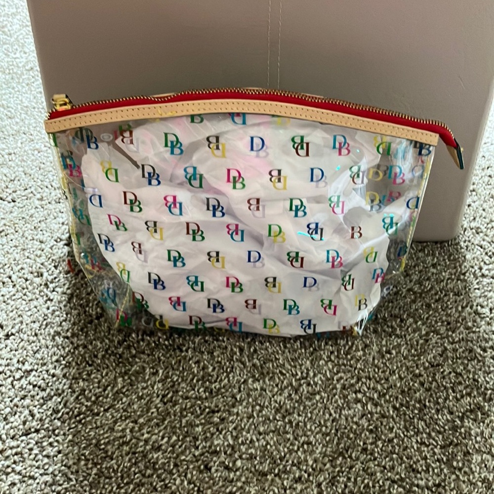 Dooney and Bourke, large cosmetic bag, leather zip top closure. 2 available